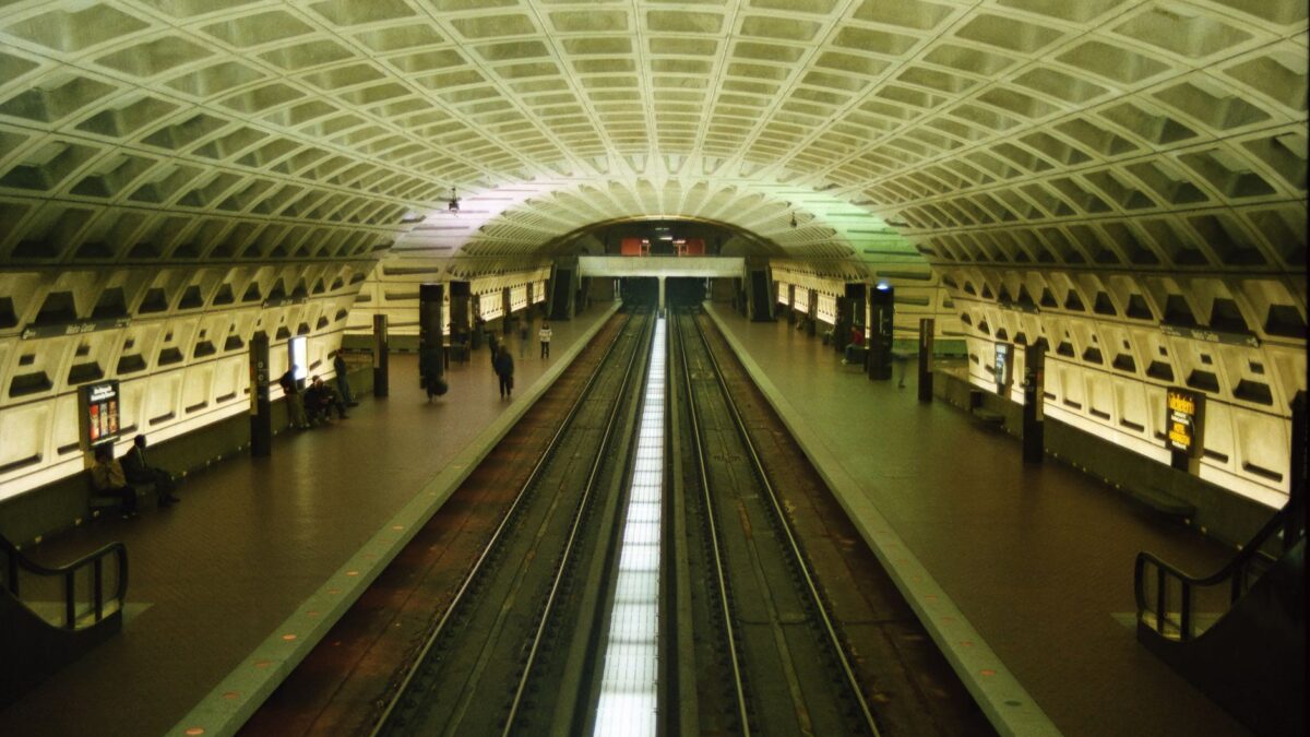Spacious metro station with concrete arches and empty train tracks in Washington, DC.