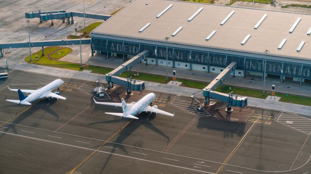 Aerial view of Abeid Amani Karume International Airport in Zanzibar, showing parked airplanes and terminal.