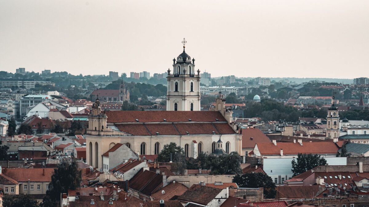 A scenic aerial view of Vilnius, Lithuania, featuring a historic church amidst the cityscape.