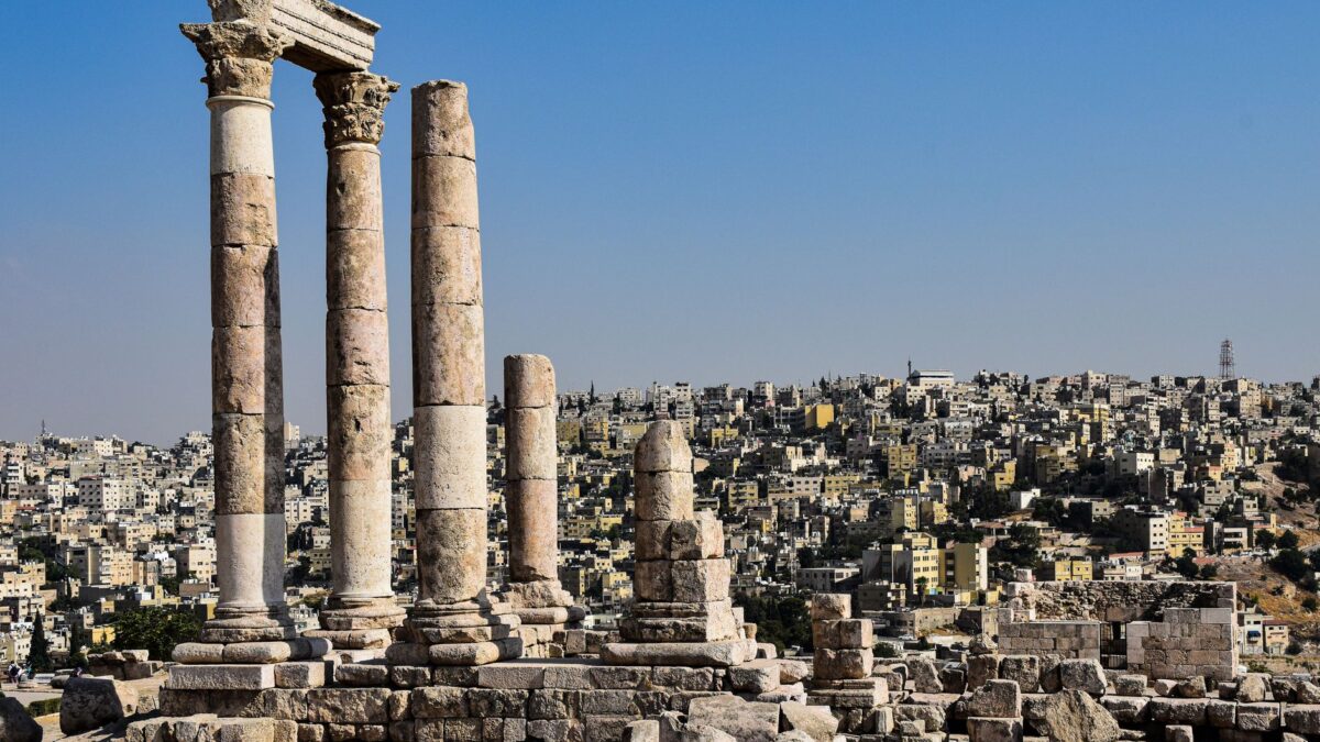 View of the ancient columns at Amman's Citadel with the cityscape in the background.