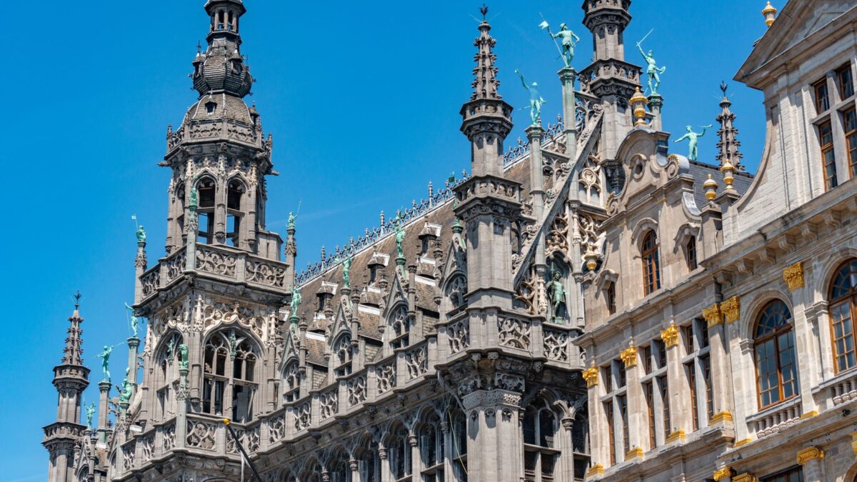 The stunning neo-gothic architecture of the Brussels City Museum against a clear blue sky.