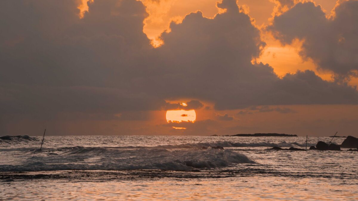 Breathtaking sunset view over the ocean waves at Unawatuna beach in Sri Lanka.
