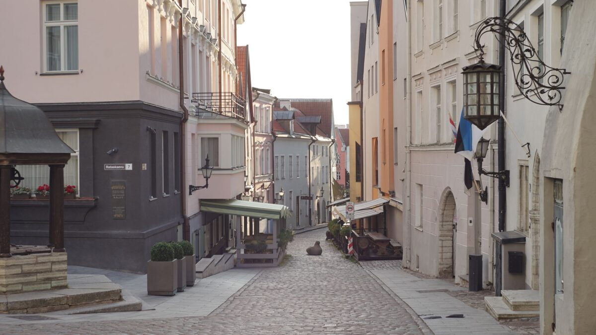 Cobbled street in Tallinn's Old Town lined with historic buildings. Calm, picturesque view.