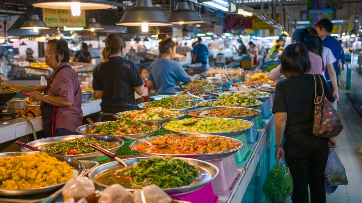 Explore the bustling atmosphere of a Bangkok street market with colorful Thai cuisine.