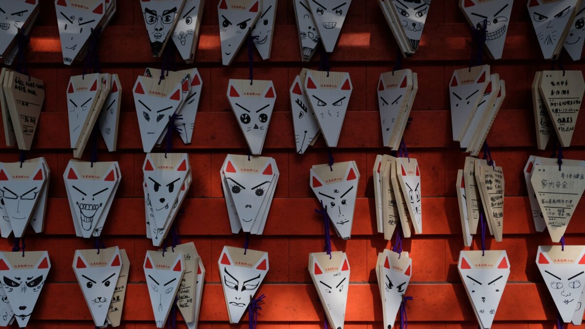 Japanese fox-faced ema plaques display at shrine in Tokyo, Japan.