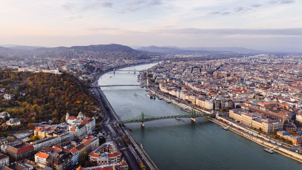 Beautiful aerial view of Budapest with the Danube River and iconic bridges at sunset.