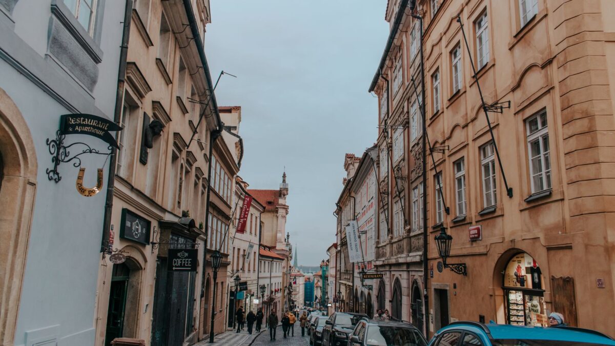 Explore the charm of a historic Prague street with classic architecture and cobblestones.