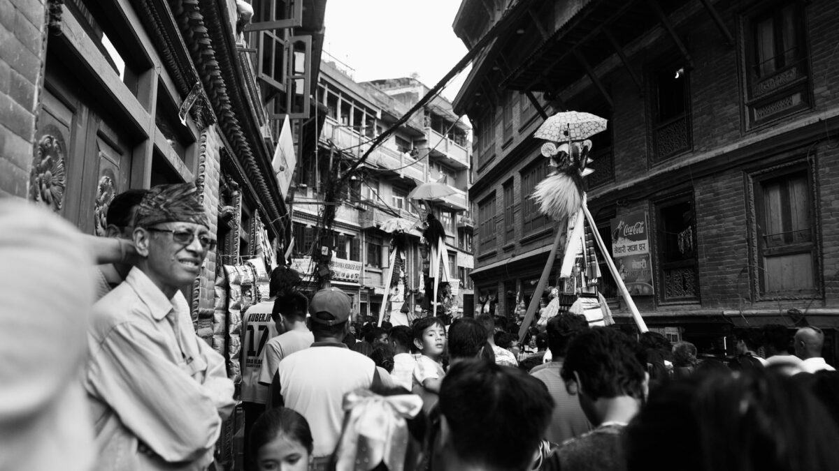 Crowded street scene during a vibrant cultural festival in Nepal.