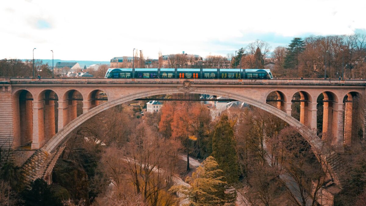 Picturesque view of a train crossing the Viaduc in Luxembourg City during autumn.