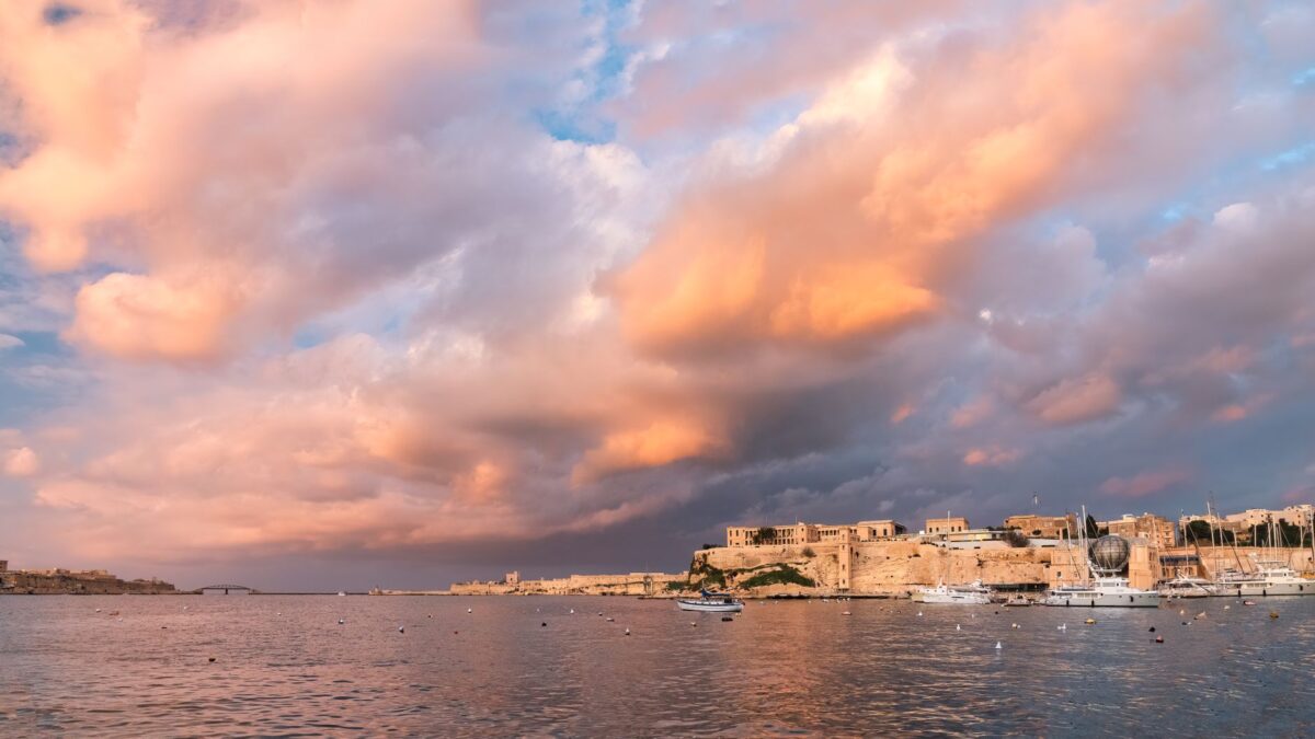Breathtaking sunset view over Valletta, Malta's historic waterfront cityscape.