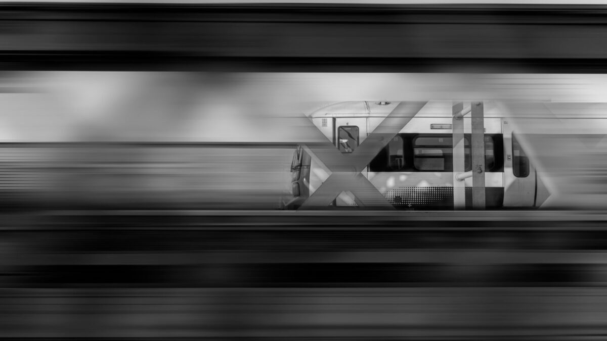 Dynamic black and white image capturing the motion of a fast train in London, England.