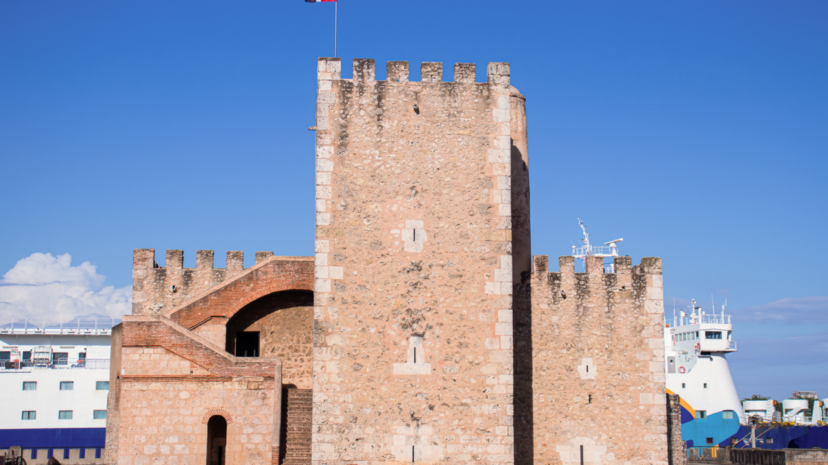 Old stone fortification, Fortaleza Ozama, under clear blue sky in Santo Domingo, Dominican Republic.