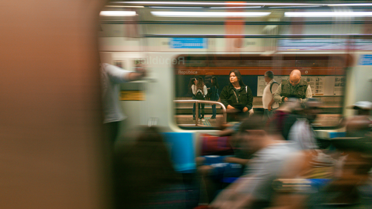 Blurred subway train capturing the essence of urban transit with passengers on a busy platform.