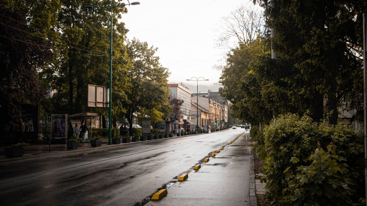 A wet street in Ilidža, Sarajevo captures rain reflections and urban life after rainfall.