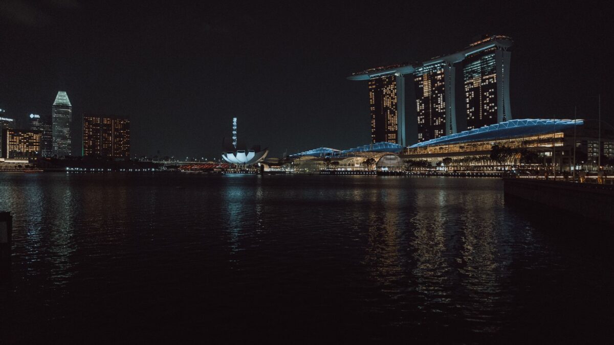 Captivating night view of Singapore skyline featuring Marina Bay Sands and cityscape reflections.