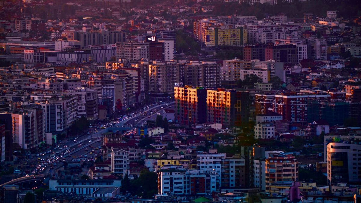 Aerial view of Tirana, Albania's vibrant cityscape, captured during golden hour, highlighting urban architecture.