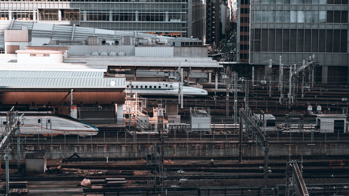 Aerial view capturing the bustling Tokyo railway station with modern train tracks and buildings.
