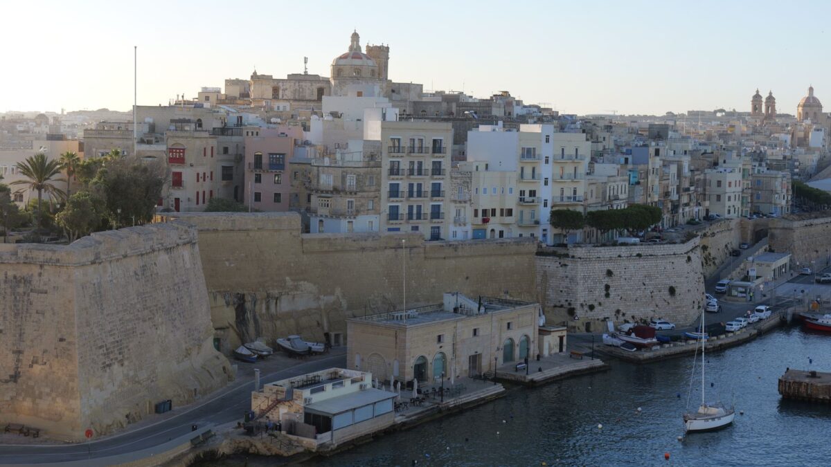 A stunning aerial view capturing Valletta's historic architecture and coastal skyline at dusk.