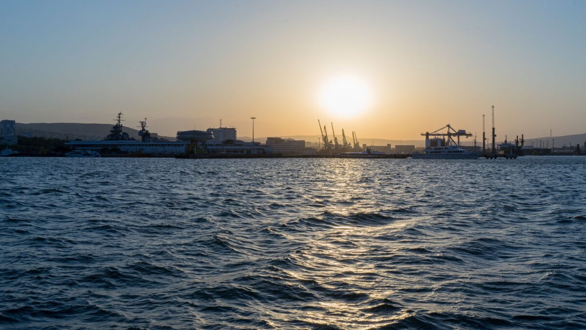 Beautiful sunset view over the harbor of Novorossiysk, showcasing the vibrant sea and skyline.